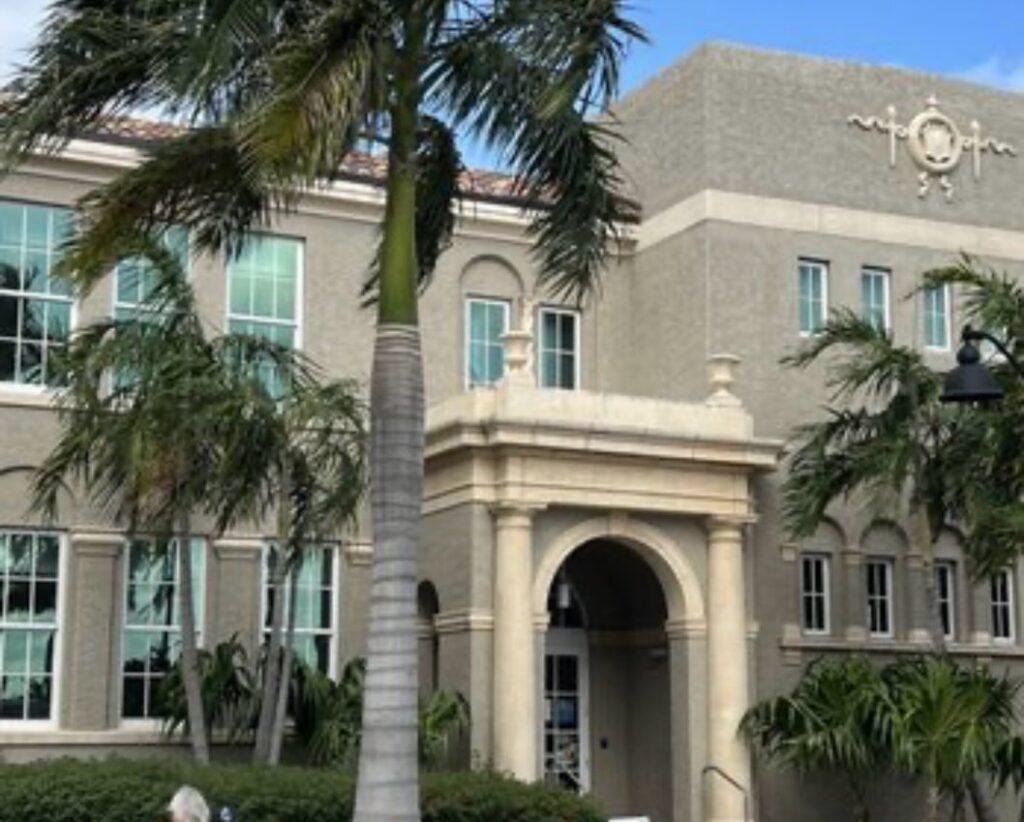 Historic building with palm trees.