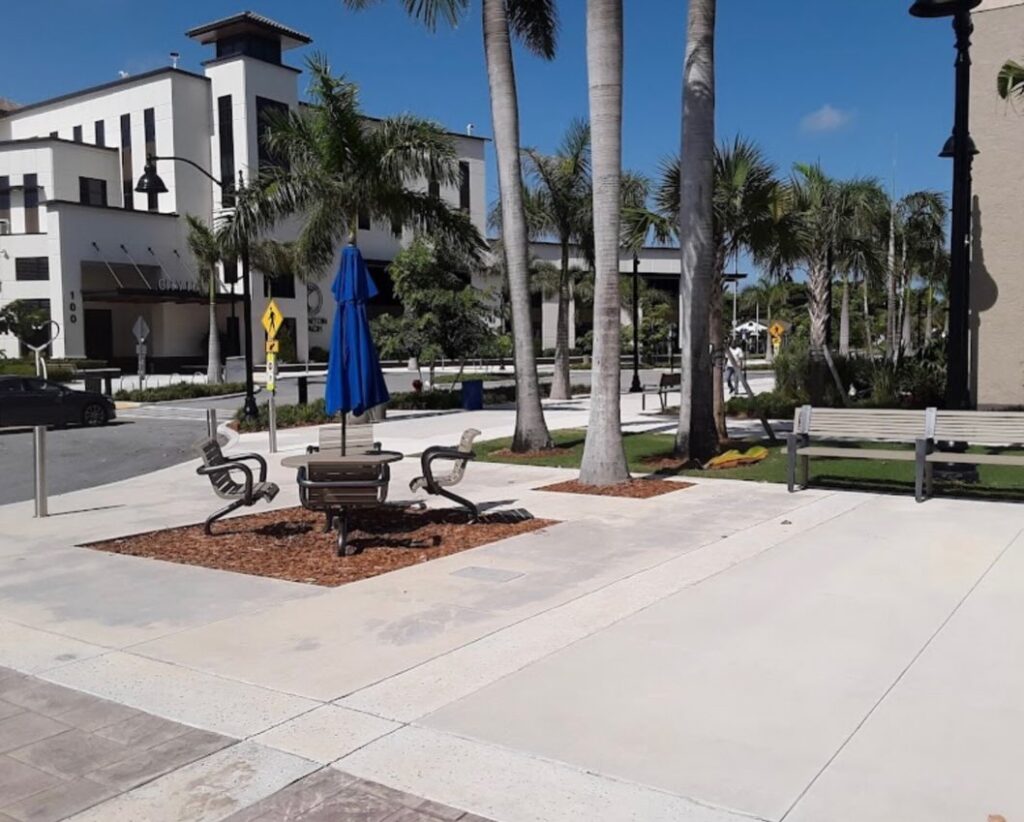 Park area with benches and palm trees
