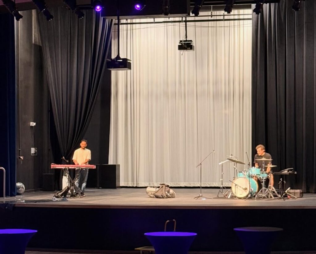 Musicians performing on a stage.